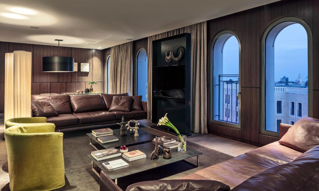 Luxury living room with large windows, modern furniture, and elegant decor.